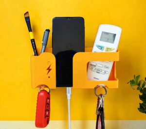 Wall Mobile Holder | Multi-Purpose Mobile Stand | Remote Holder Wall Mobile Holder | Multi-Purpose Mobile Stand | Remote Holder & Mobile Charging Stand, Phone Stand for Charging with Pen and Key Holder Useful Gadget- Orange