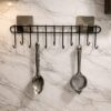 Wall Mounted Kitchen Utensil Hanger with Adhesive Hooks | Heavy Duty Metal Spoon & Ladle Holder Rack | No Drilling Kitchen Organizer for Cooking Tools, Cups & Accessories (Black)